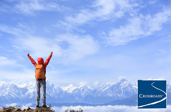 Prioritizing-Putting-Your-Recovery-First person Putting your recovery first standing on a mountaintop