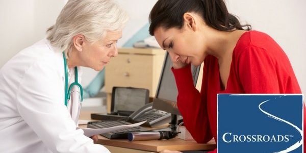 doctor recognizing the physical toll of addiction in woman