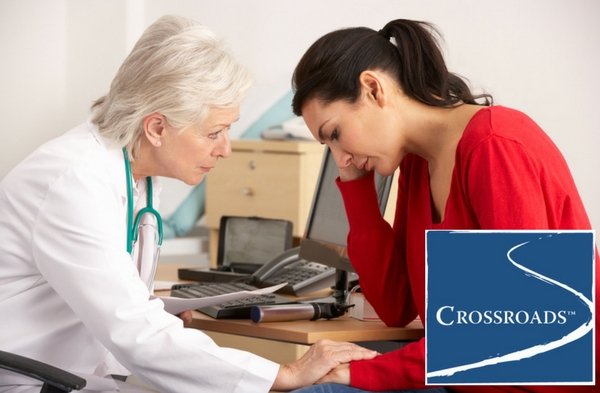 doctor recognizing the physical toll of addiction in woman