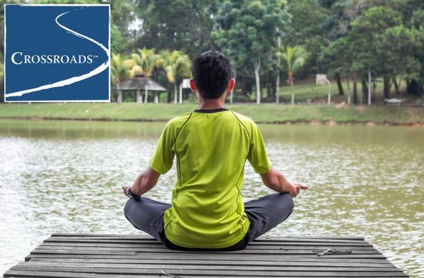 man using holistic meditation yoga on a dock to enhance addiction treatment healing