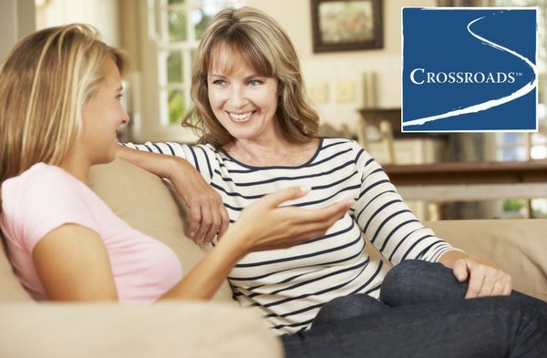 mother talking to daughter on couch about addiction