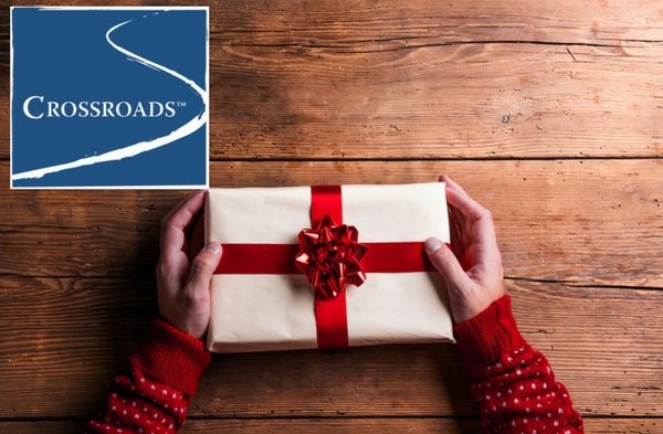 man holding christmas present for a loved one in recovery