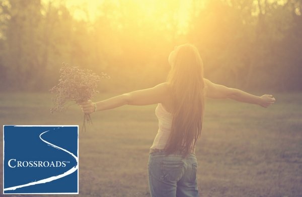 woman holding flowers and embracing the sun to start the year off fresh