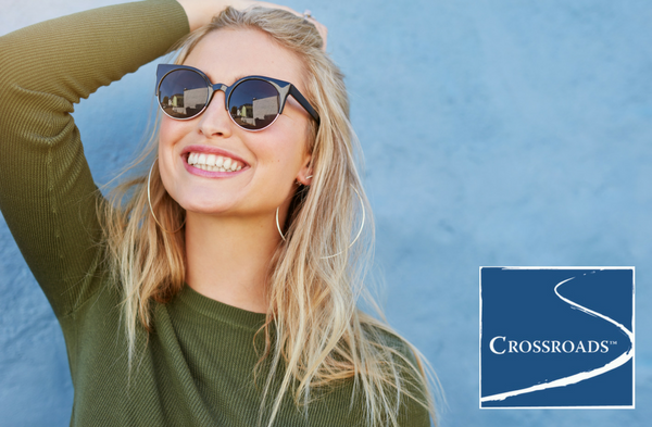 woman smiling in the sun after finding freedom in recovery