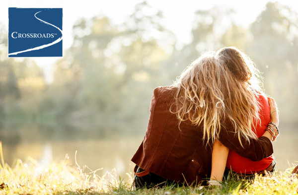 two women leaning on each other trying to figure out what to do for a loved one resistant toward addiction treatment