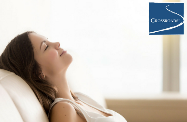 woman leaning back with eyes closed Practicing Mindfulness at Crossroads