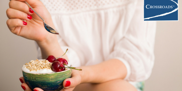 Building a Healthier Diet to Support Addiction Recovery.CRBlog2 woman eating healthier diet for addiction recovery