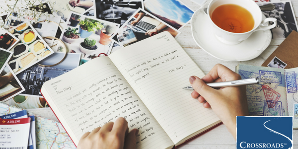 woman drinking tea and journaling to support addiction recovery