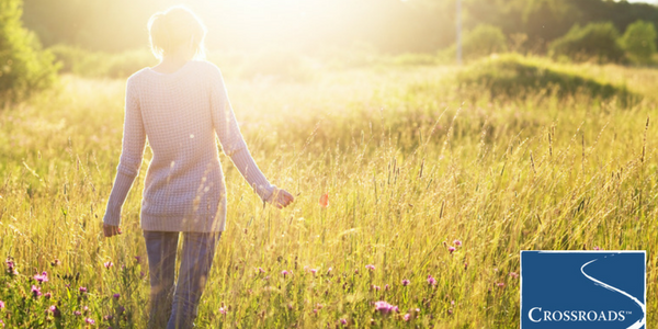 Embracing Nature as Part of Addiction Recovery.CRBlog4 woman walking in field and embracing nature as part of addiction recovery