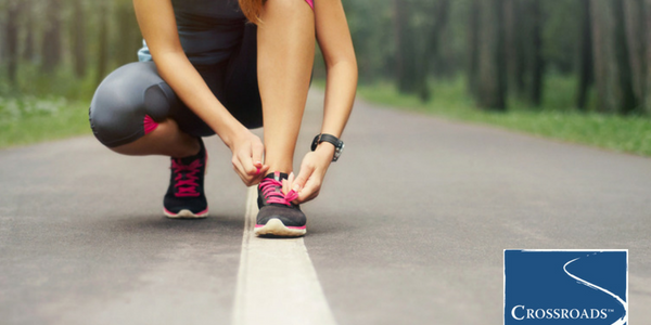 Reducing Boredom in Recovery and Increasing Motivation.CRBlog1 woman tying running shoes along path to increase motivation in recovery