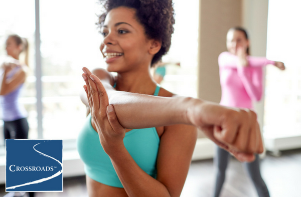women stretching and socializing through women's recovery program