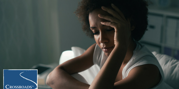 woman in bed dealing with post-acute withdrawal syndrome