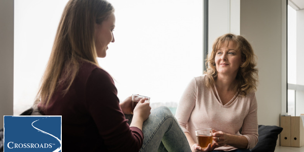 mother and daughter drinking tea and talking about building an addiction recovery support system
