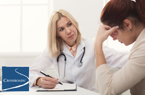 doctor reviewing woman's addiction recovery support system