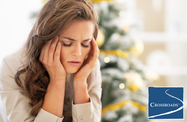 woman massaging head dealing with common holiday stressors in recovery