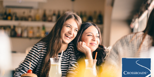 two sisters enjoying a meal to help cope when a parent is in addiction treatment
