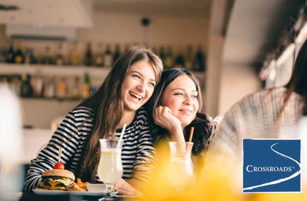 two sisters enjoying a meal to help cope when a parent is in addiction treatment