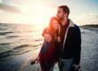 husband hugging smiling wife during walk on beach after recovery from mental health and substance use at Crossroads