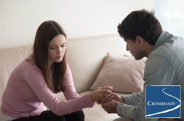 man holding wife's hands asking if she knows her drinking is becoming problematic