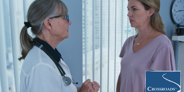 woman consulting doctor about the factors to consider when choosing a drug rehab center for her son