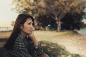 woman sad at park with ocd needing an ocd treatment program at Crossroads