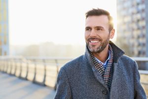 man smiling and walking bridge after Crossroads' personality disorder treatment program