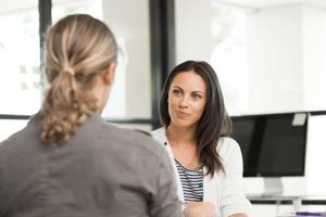 two women discussing eating disorder treatment