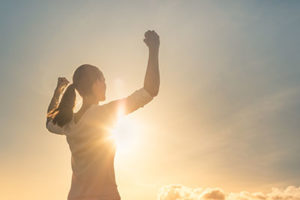 woman raising hands up in victory at binge eating disorder treatment center