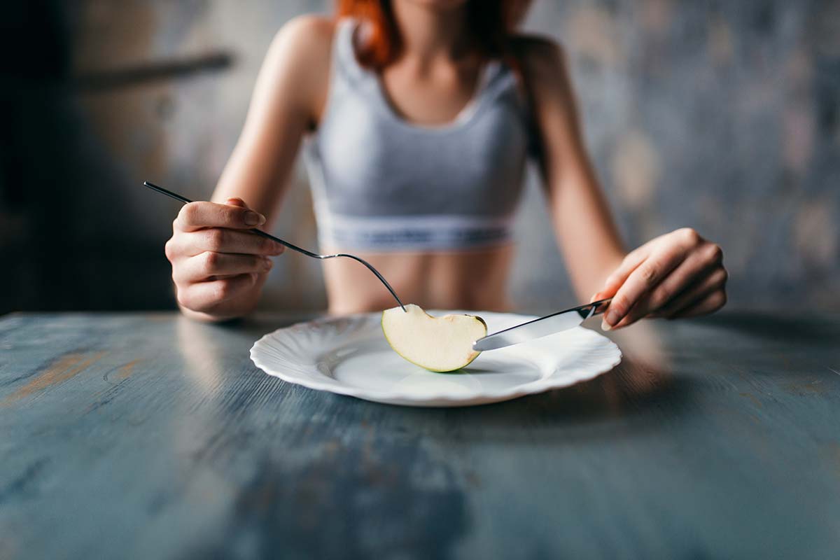 anorexia-vs-bulimia woman staring at food wondering about anorexia vs bulimia