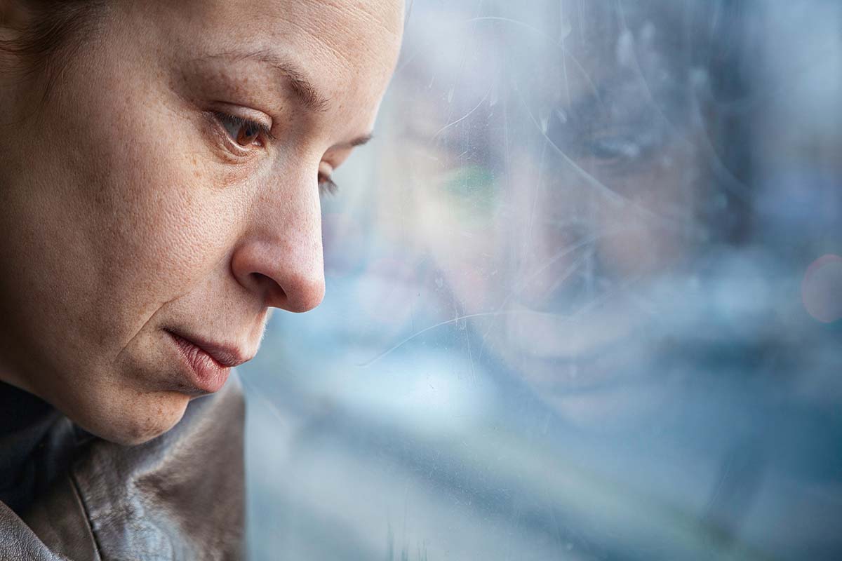 do-i-have-depression woman looking out the window wondering do I have depression