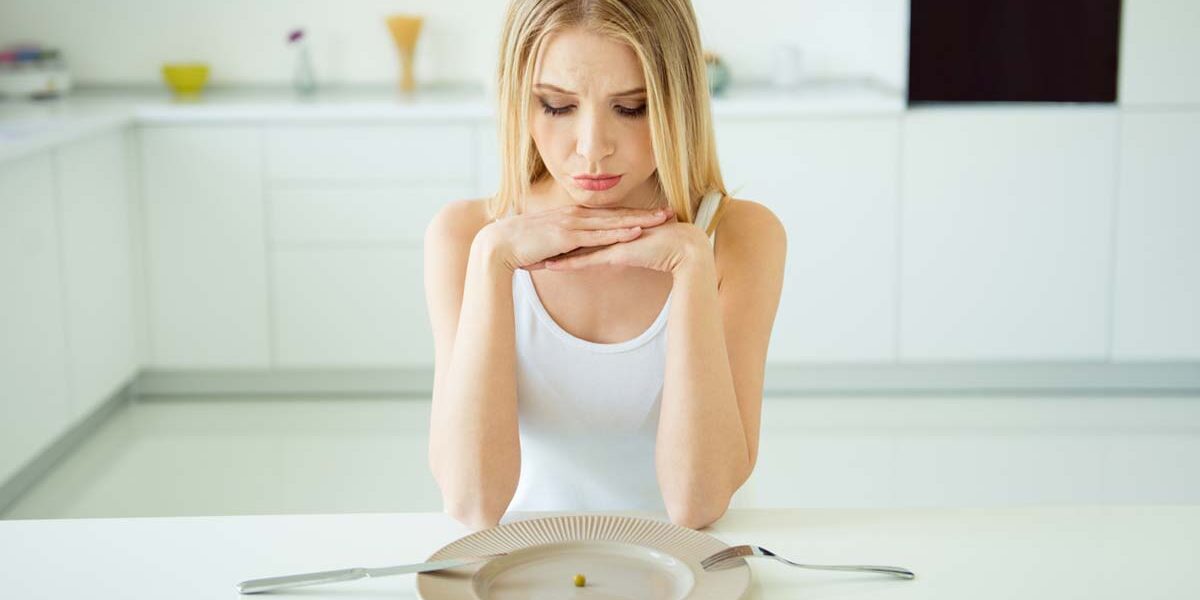 woman with clear plate pondering common eating disorders