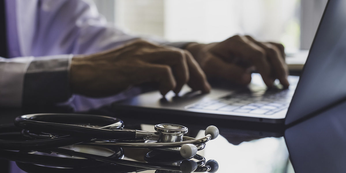person using laptop to avail themselves of telehealth services
