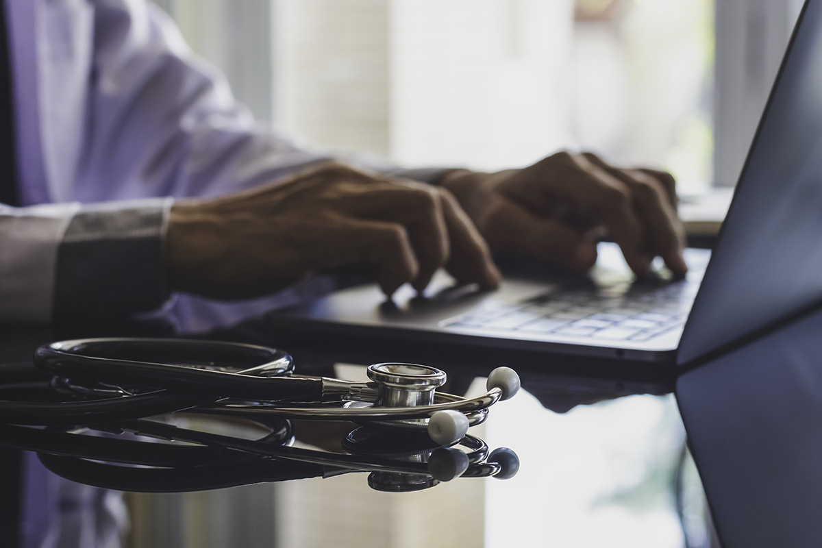 telehealth services person using laptop to avail themselves of telehealth services