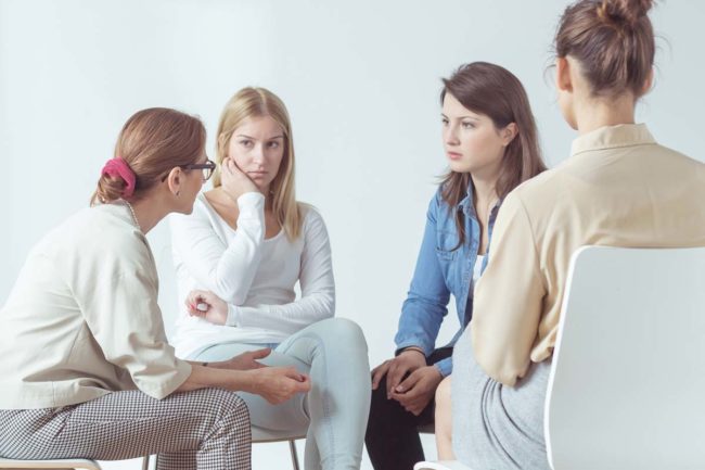 a group of women discuss the importance of women's addiction treatment