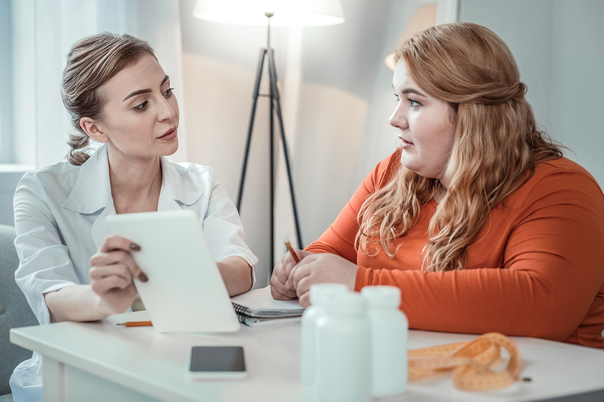 eating disorder definition a woman discusses the eating disorder definition with her doctor