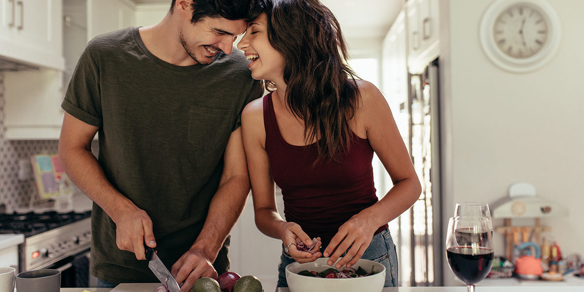 a man and woman cook together as they discuss helping your loved one in recovery