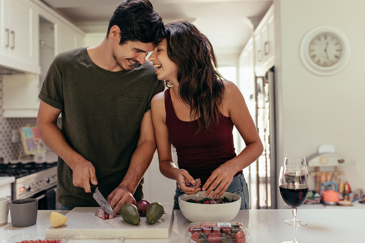 a man and woman cook together as they discuss helping your loved one in recovery