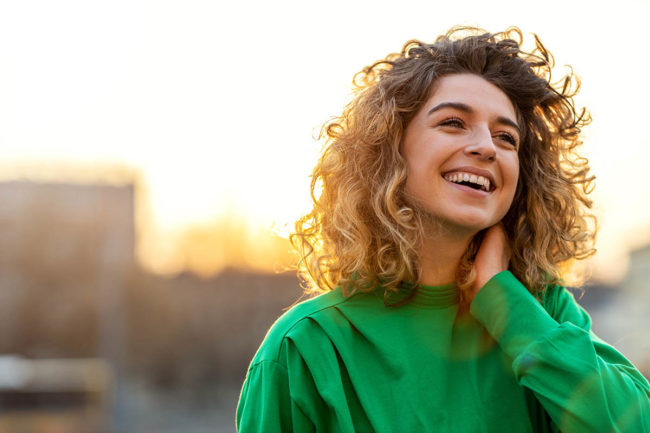 woman happy after learning about women and eating disorders and receiving treatment
