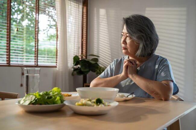 3-When-to-Seek-Eating-Disorder-Treatment a woman wonders if she should seek eating disorder treatment in maine