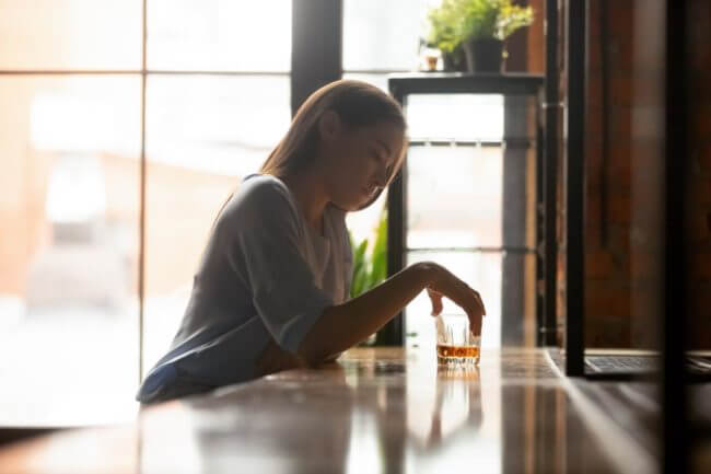 a woman suffers from complications associated with alcohol addiction