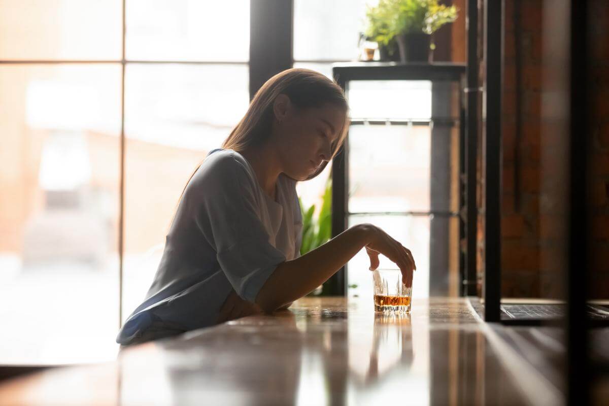 a woman suffers from complications associated with alcohol addiction