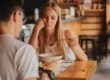 a woman sits with a friend as she struggles with the effects of eating disorders