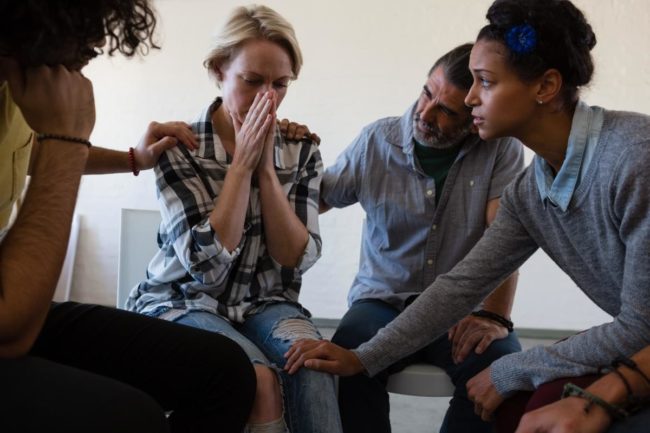 a group of people comfort a young woman with alcohol addiction quotes