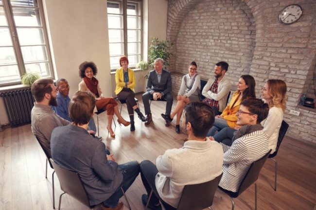 a group of people discuss what is group therapy like