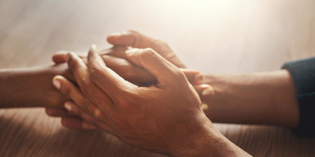 How to Help Someone With Anxiety two people holding hands learning how to help someone with anxiety