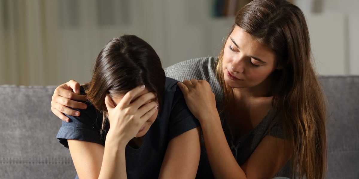 How to Help Someone With Bipolar Disorder a woman consoling her woman friend and demonstrating how to help someone with bipolar disorder