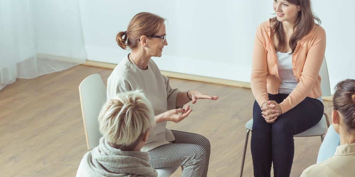 a woman talking about group therapy benefits in group therapy session