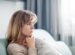 a woman sitting on couch thinking about needing help for borderline personality disorder